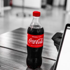 Coca-Cola plastic bottle on wooden table