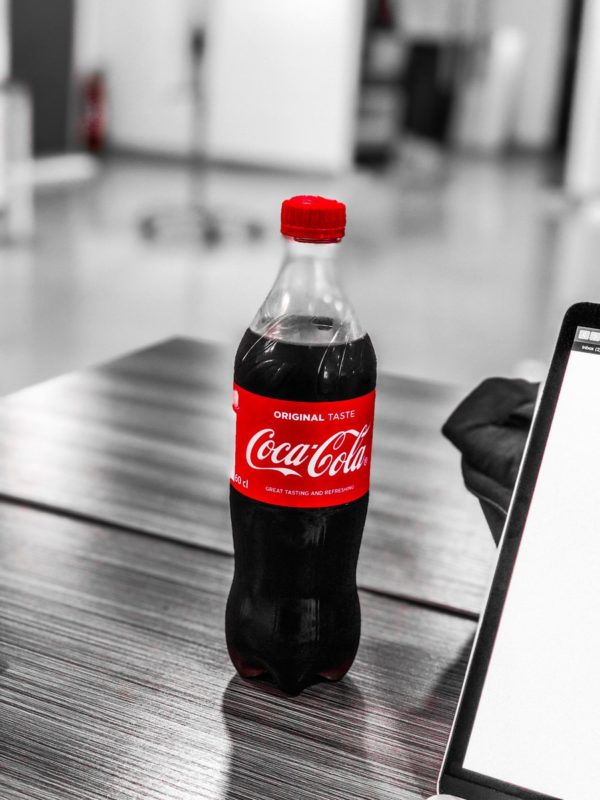 Coca-Cola plastic bottle on wooden table